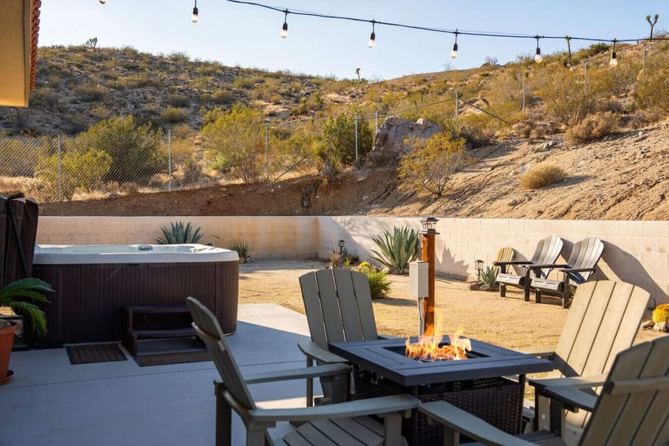 Gather around the fire, move to the table, end the night in the hot tub — the outdoor living space has a perfect flow for every moment of the evening