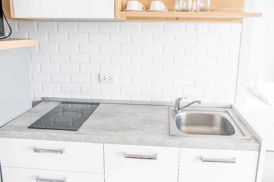 Apartment, City View | Private kitchenette | Microwave, stovetop, electric kettle, cookware/dishes/utensils