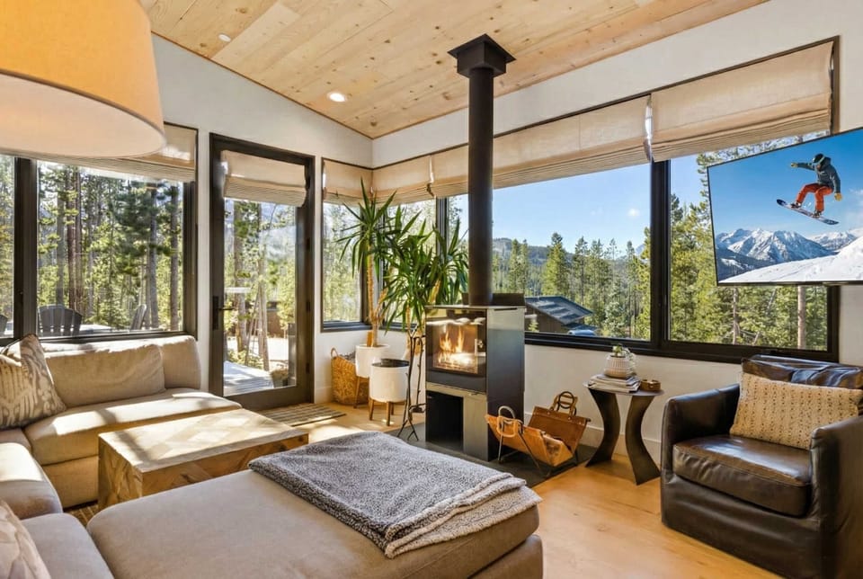 Living room (main floor): Wood-burning fireplace, Smart TV, mountain views