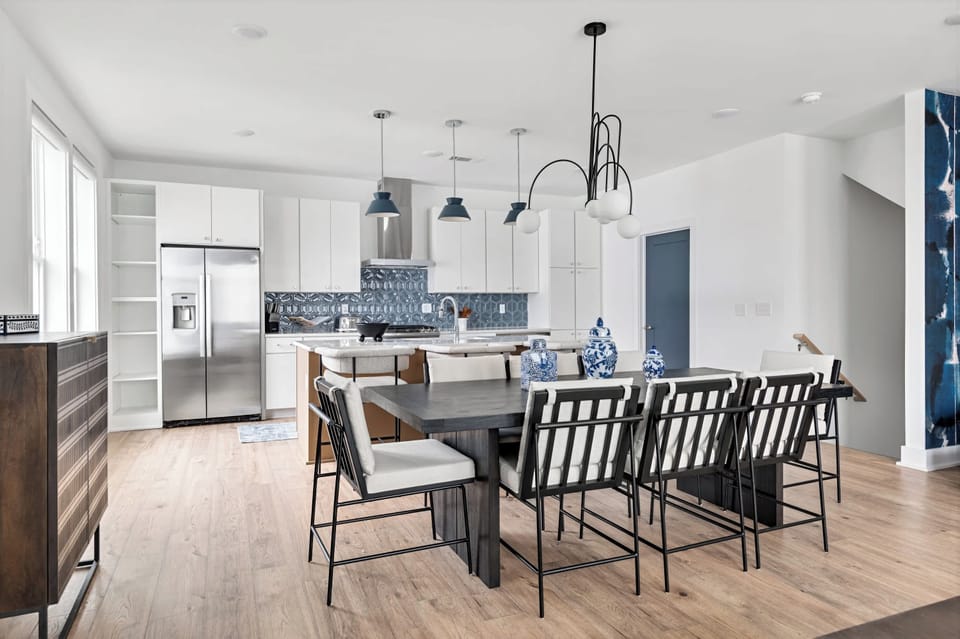 Open kitchen and dining flow so the group can gather while someone grills, keeping the cook in the conversation