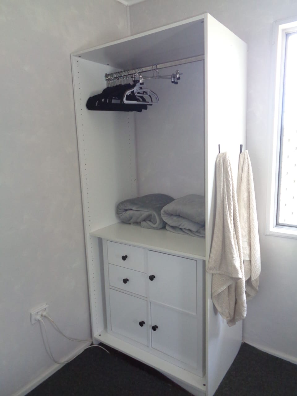 bedroom 2 storage, coat hangers, blankets and towels