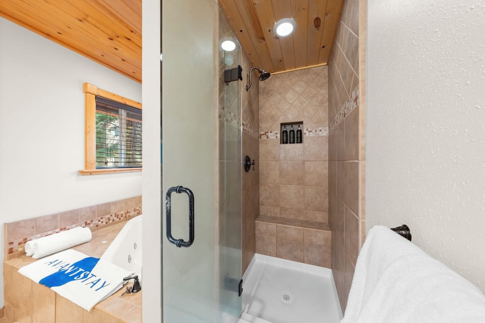 The primary bedroom's ensuite features a shower and a soaking tub.