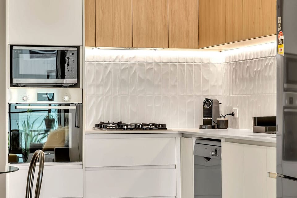 Modern kitchen appliances with espresso machine and gas cooking.