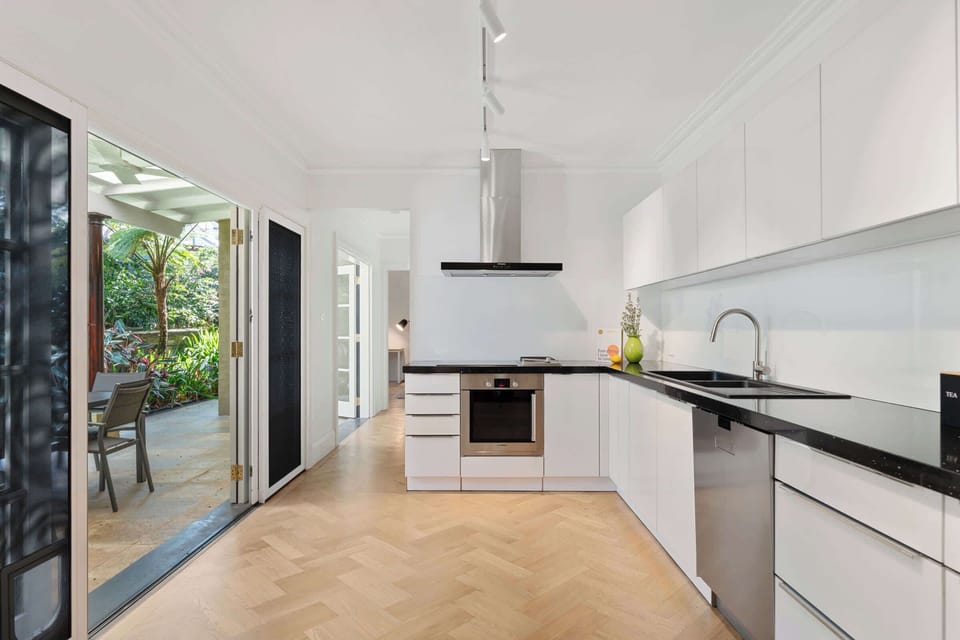 The modern kitchen comes fully equipped with everything you need for effortless cooking and entertaining. It offers direct access to the alfresco area, as well as a conveniently located bathroom, blending practicality with contemporary style.
