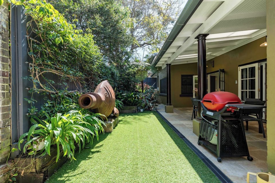 The spacious alfresco area opens directly onto the lush lawn and features a stylish outdoor setting with seating for up to six. Perfect for leisurely gatherings, it also includes a dedicated barbecue space for relaxed outdoor dining and entertaining.