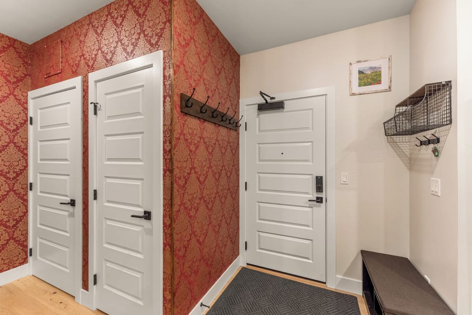 Step into your welcoming entryway with convenient coat hooks and storage baskets to organize your belongings after mountain adventures.
