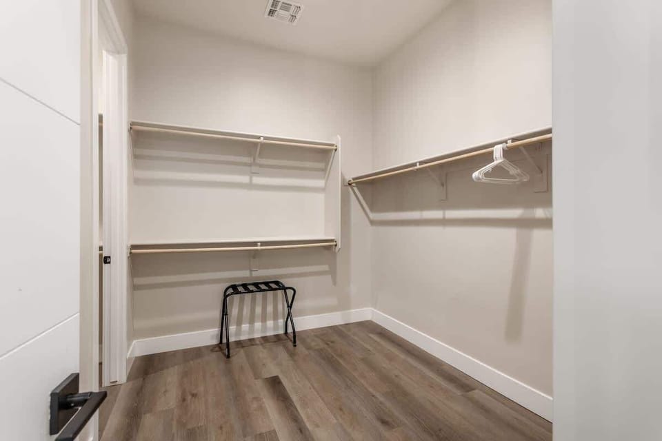 Primary bathroom with double vanities, large walk-in shower, soaking tub, and large walk-in closet.
