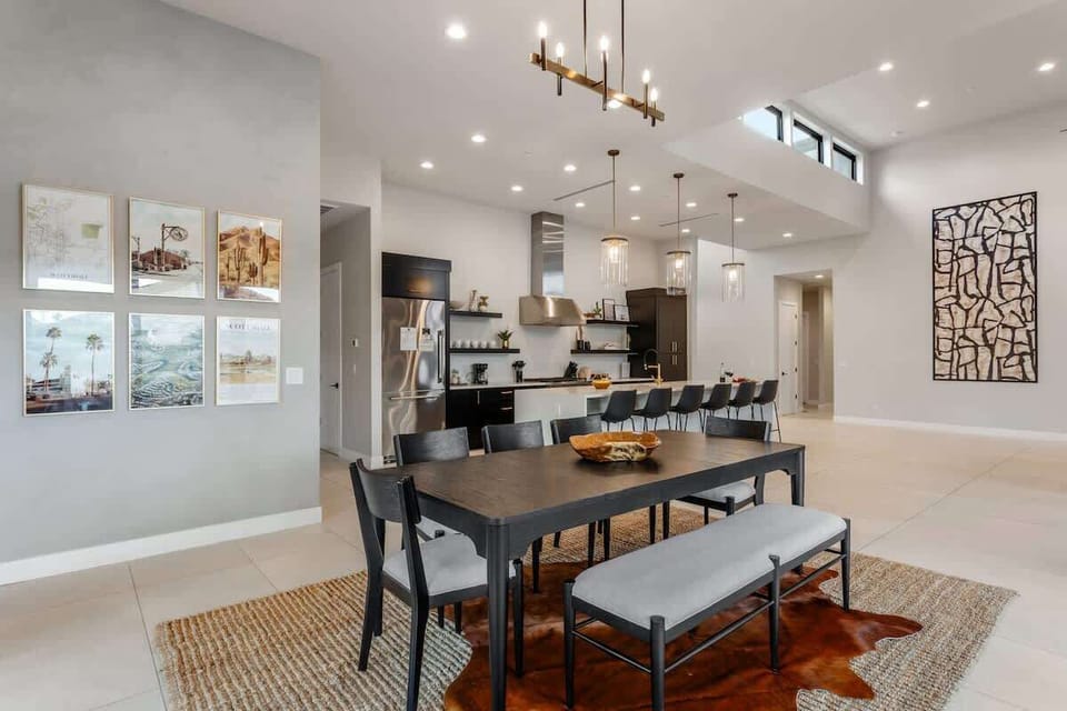 Formal dining area for 8 with a custom light fixture, and private access to the outdoor patio.