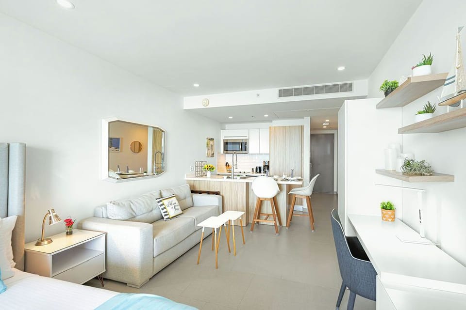 Your bright, open living space flows seamlessly from cozy sofa to breakfast bar, all designed for easy, carefree relaxation.