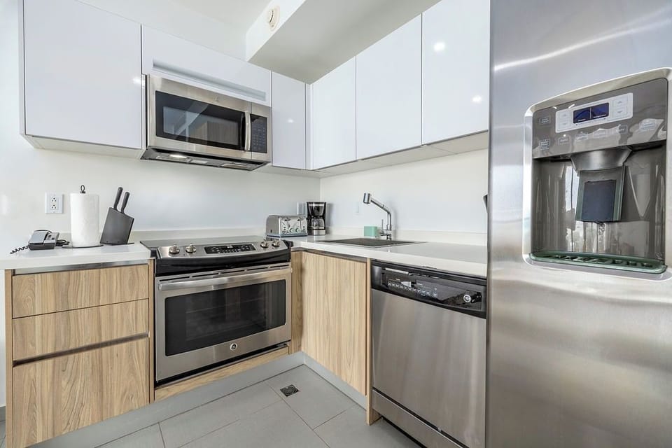 Your modern kitchen features sleek stainless steel appliances and warm wood cabinetry, creating the perfect space for home-cooked meals.