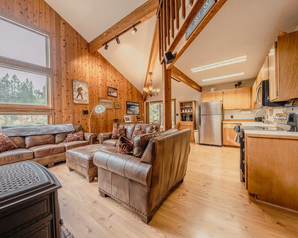 Bright open living area with leather seating and Smart TV