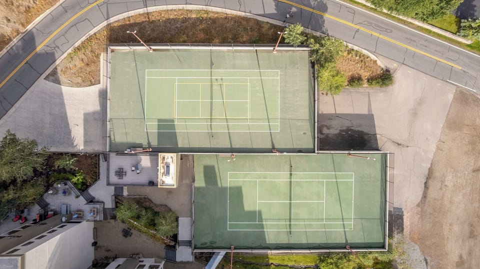 【Courts — Aerial】Full view of both courts — tennis + pickleball, steps from the lobby