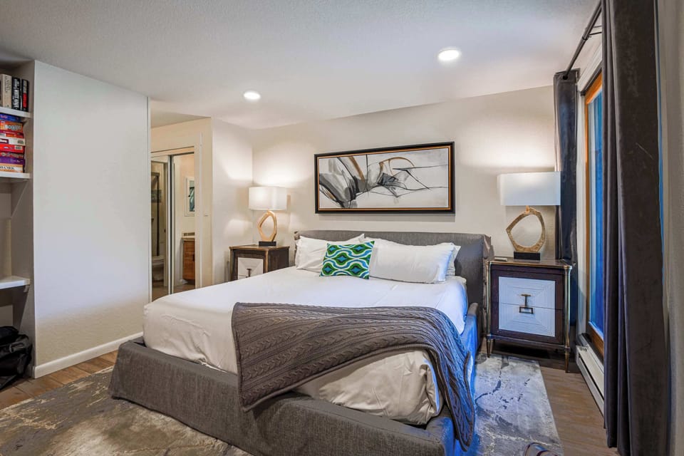 【Second Bedroom — King】Close-up on the King bed — bunks just out of frame to the right