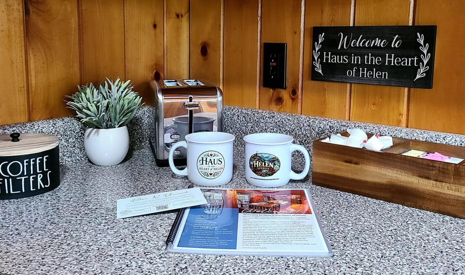 Cozy mornings start with coffee in our signature Haus in the Heart of Helen mugs—part of your welcome gift and yours to take home.