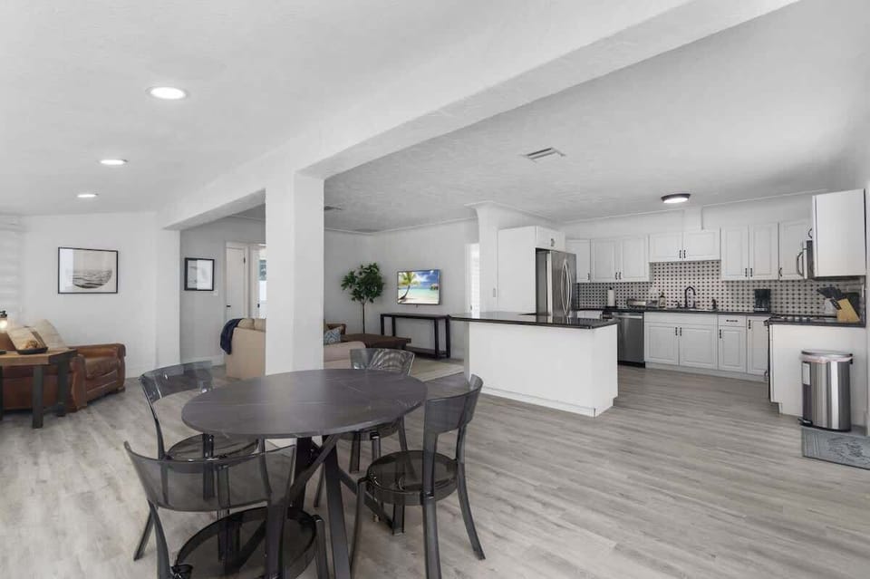 Inviting dining space with seating for four plus two stools at the kitchen counter — perfect for family meals or coffee chats.