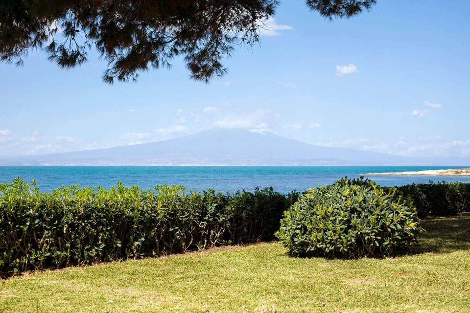 Mount Etna rising majestically across the Gulf of Catania to the north.