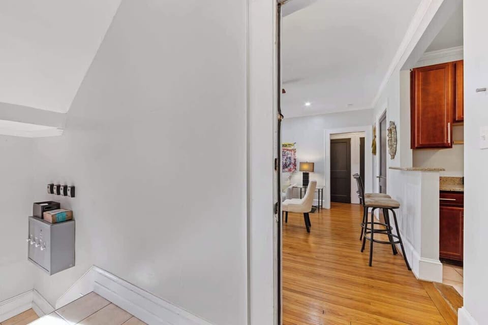 Entrance in Charlotte leading into a bright, open living space with hardwood floors and natural light. Welcoming entryway offering easy access to the kitchen, dining, and living areas for a comfortable stay.
