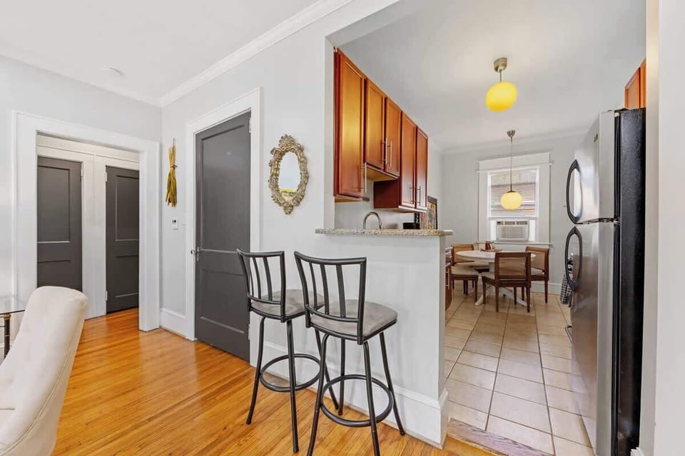 Functional kitchen in Charlotte featuring ample cabinet spacew, breakfast bar seating, and easy access to the dining area. Well-equipped layout ideal for cooking, extended stays, and everyday comfort in the city.