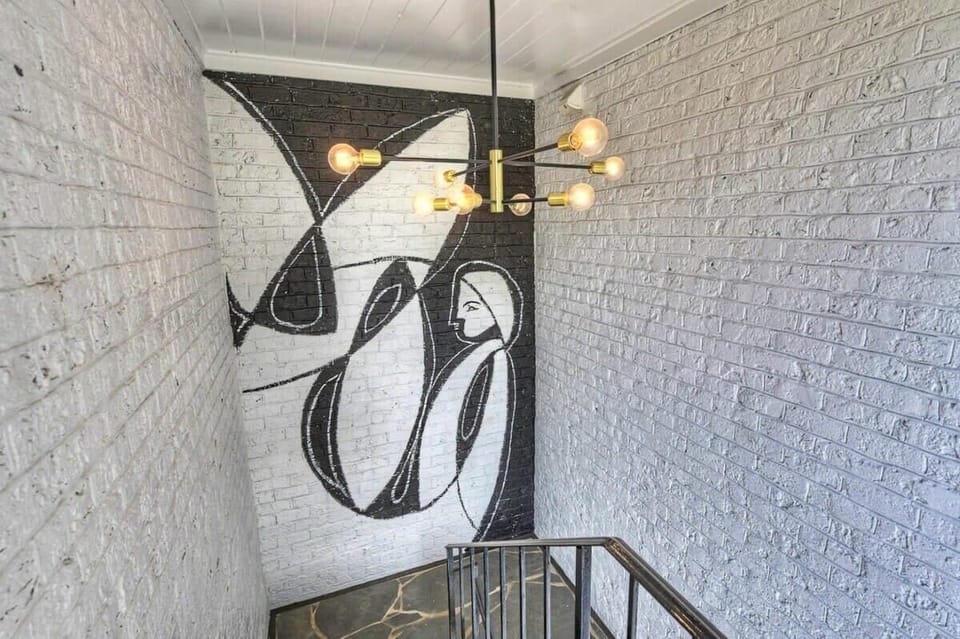 Direct stair access to the unit, offering easy entry in a quiet residential street setting.
