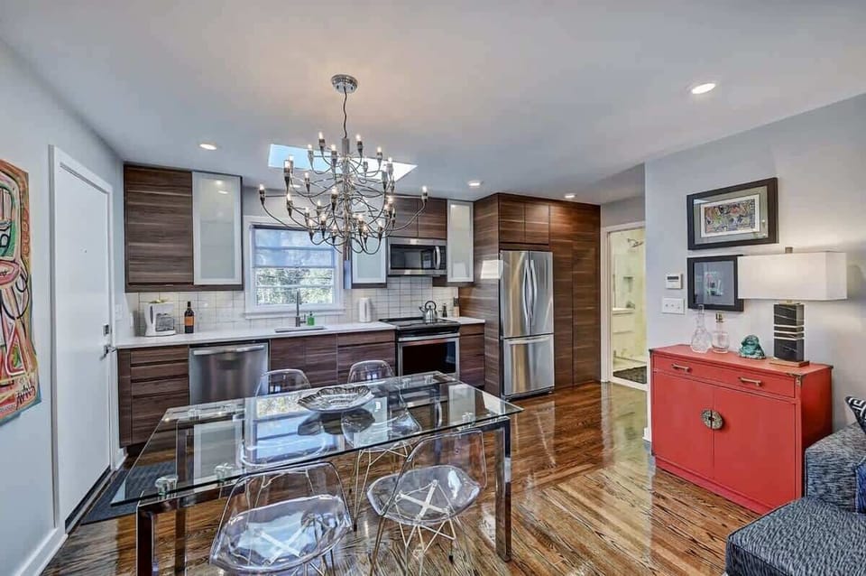 Gather around the glass dining table for a shared dinner or a quick breakfast before heading out.
