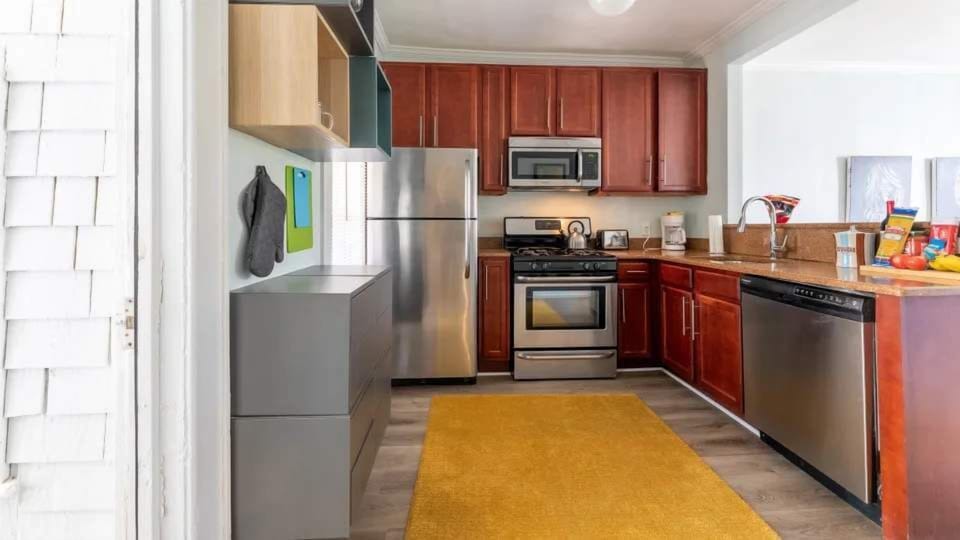 This bright kitchen features stainless steel appliances, ample storage, and generous counter space for easy meal prep. A clean and functional space designed for everyday comfort.