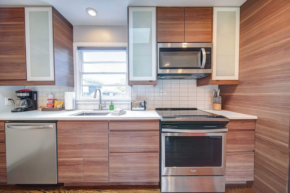 This fully equipped kitchen is neatly tucked near the dining area for seamless serving and entertaining.