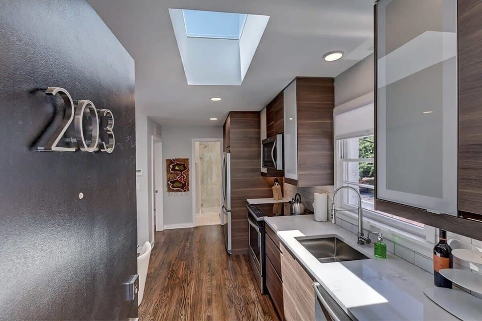 Open layout upon entry featuring a fully equipped kitchen and comfortable living area.
