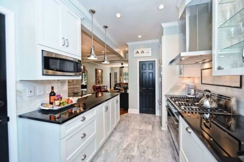 Sleek surfaces and bright lighting make this kitchen a beautiful place to work.