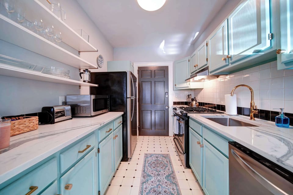 Prepare fresh meals in this bright galley kitchen, complete with a gas stove and a full-sized refrigerator for your convenience.