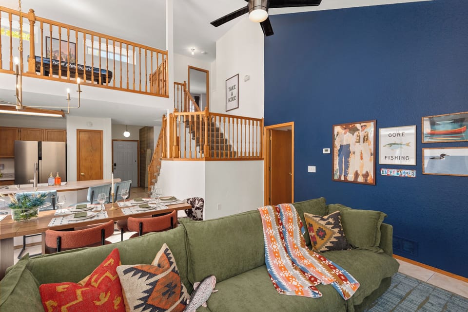 Living room with loft area and ceiling fan
