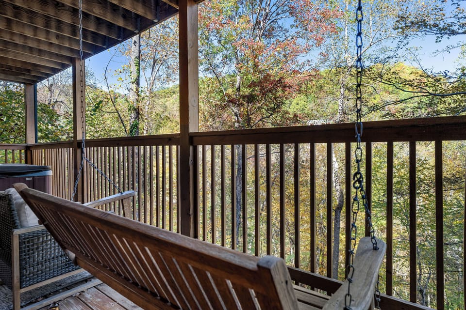 Rocking chairs & porch swing with peaceful forest views