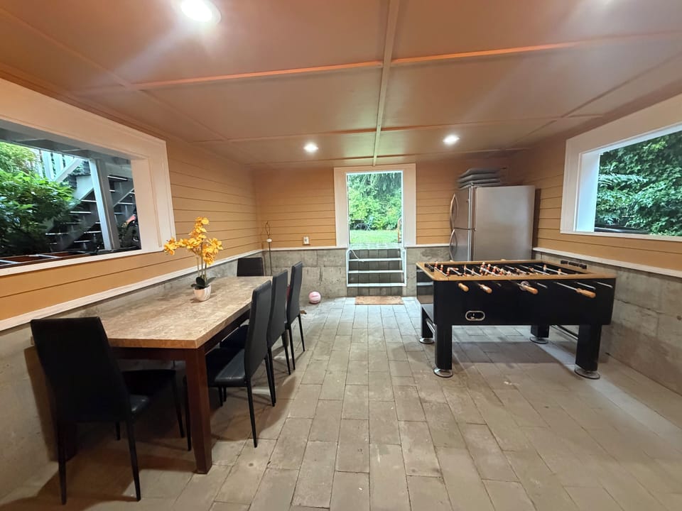 Shared covered patio with table and foosball (fridge private) accessing backyard