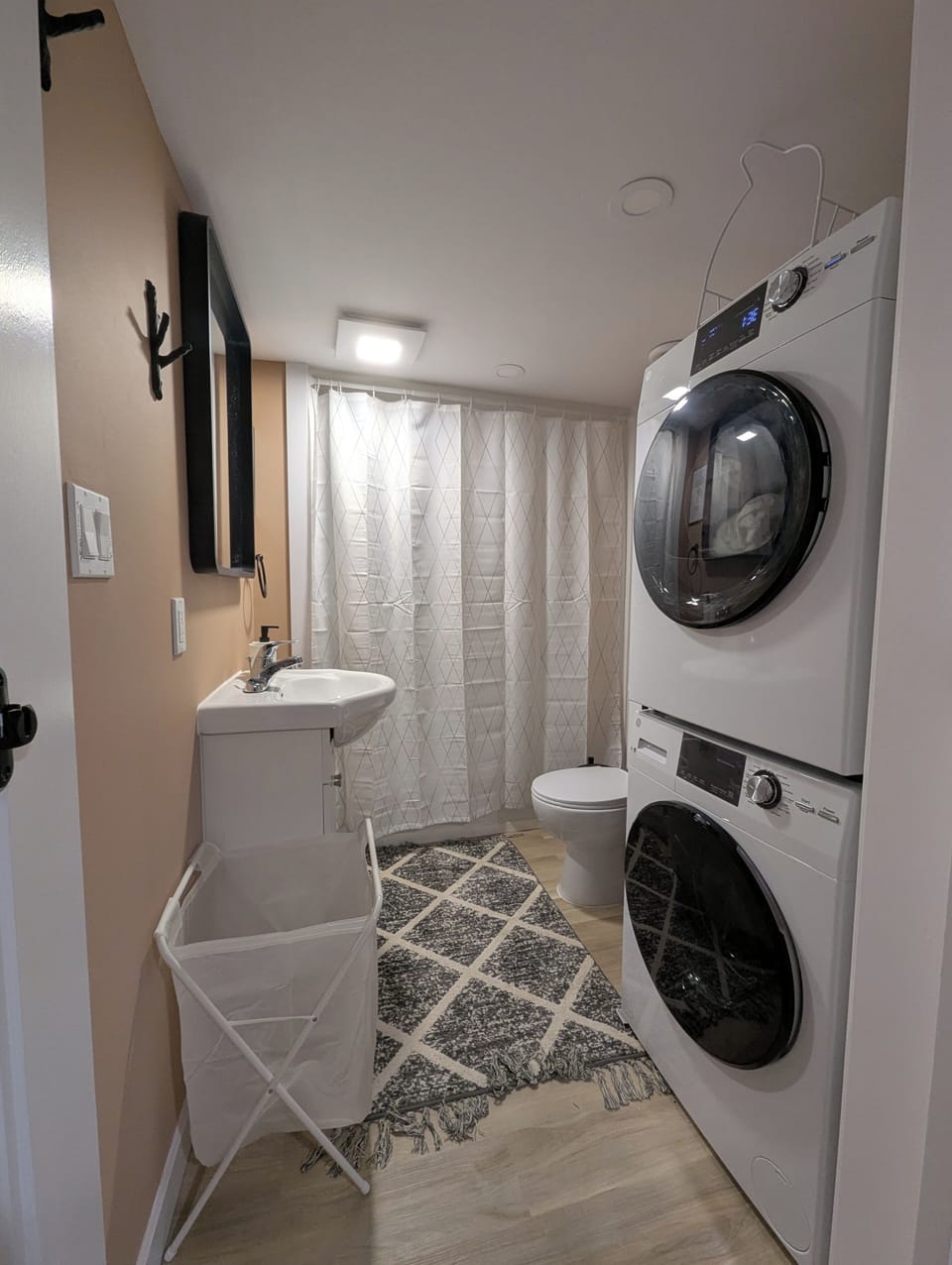 full sized bathroom with washer and dryer