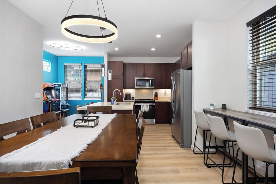 Spacious dining table with modern lighting and open-concept layout!