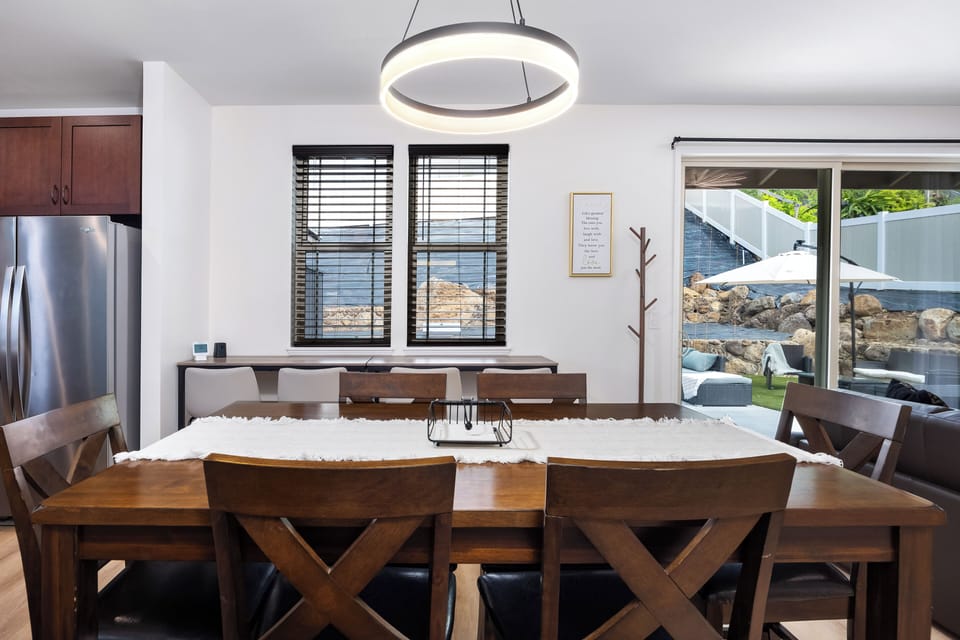 Bright dining space with modern lighting and easy outdoor access!
