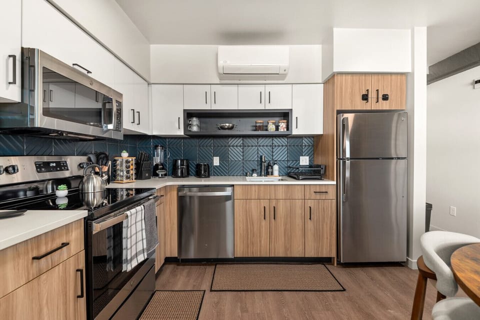 - Contemporary kitchen with sleek cabinets and appliances   - Coffee station, toaster, blender, and dishwasher ready   - Spacious layout perfect for cooking and dining together
