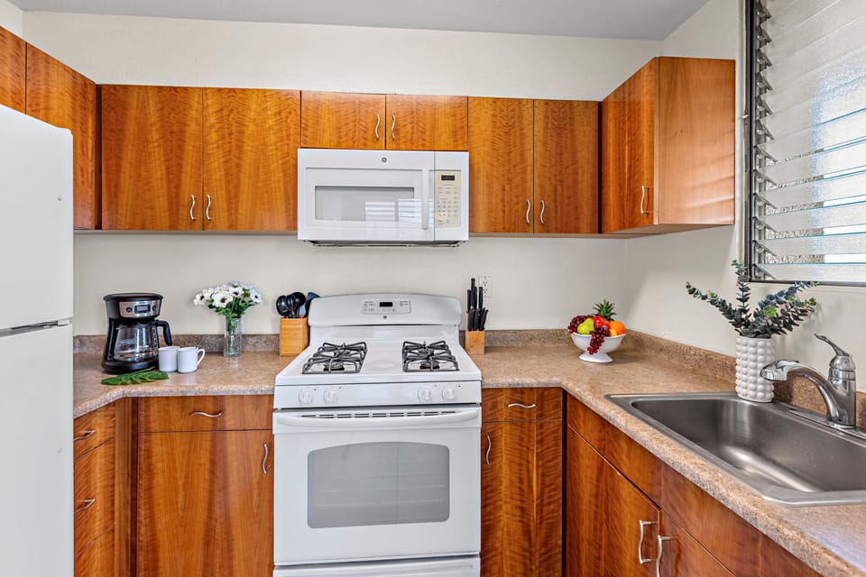 Fully equipped kitchen with cookware, utensils, and appliances — perfect for preparing home-cooked meals in Maui.