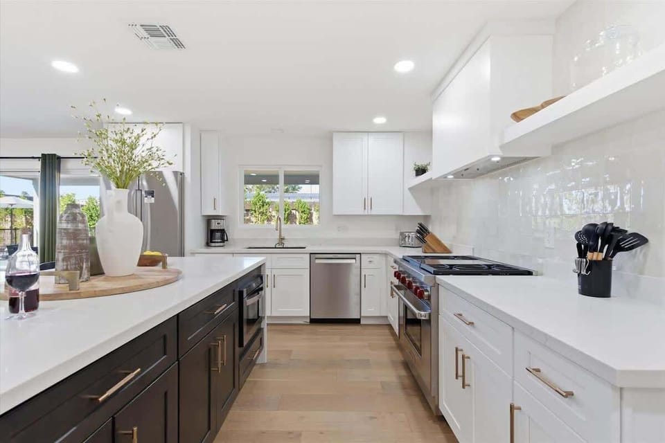 Fully equipped kitchen with stainless steal appliances and a kitchen island with bar seating for 3 guests.