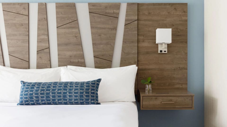 Settle into serene sleep with soft linens and modern accents.
