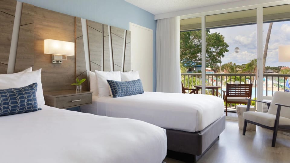 Stretch out on crisp beds with breezy balcony access.