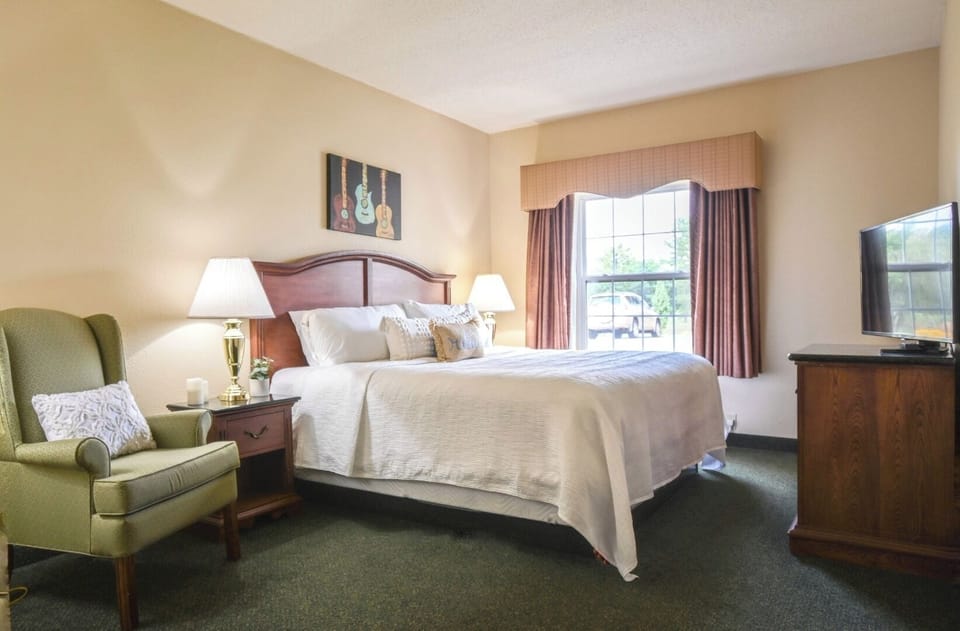 Relax in a spacious king room with TV and armchair.