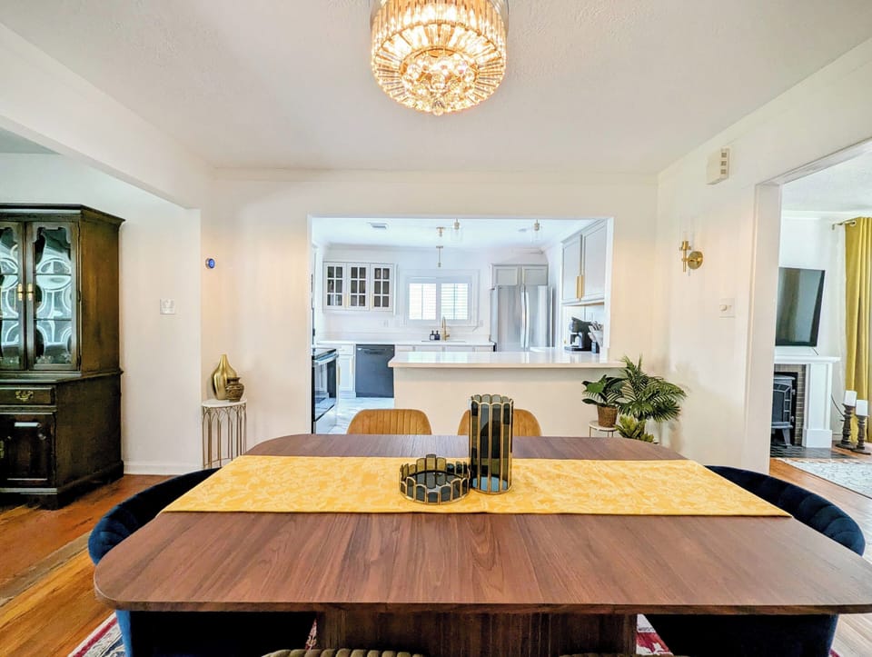 The dining area is connected to the kitchen, living, and patio