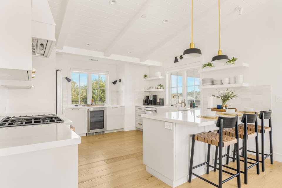 The kitchen features barstool seating, ample counter space and reliable appliances. (Main house)
