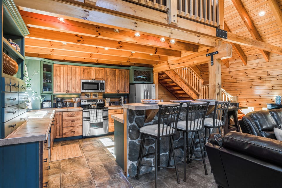 Spacious kitchen with modern appliances and barstool seating for casual dining.