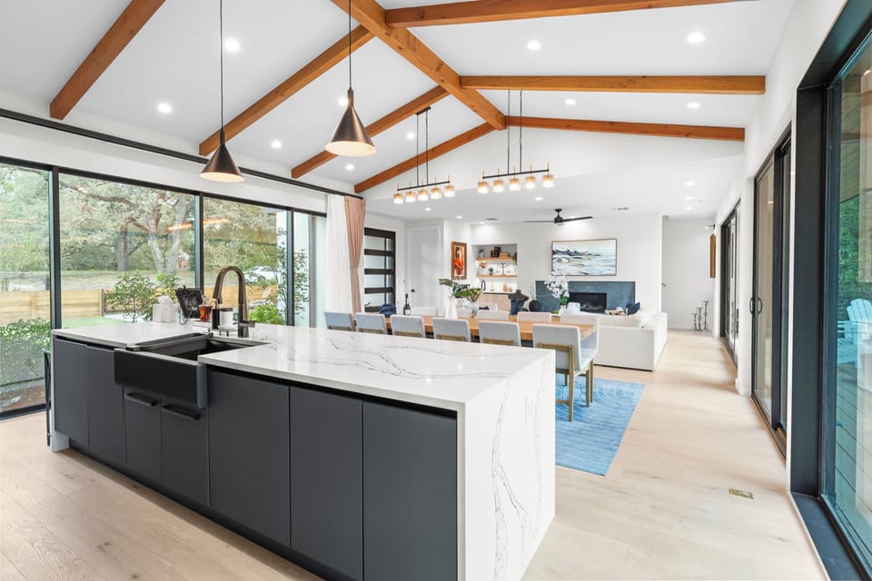 Modern kitchen with island and barstool seating. (Main House)