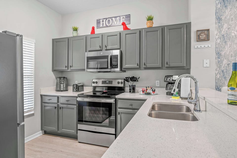 Modern kitchen with gray cabinets and stainless steel appliances