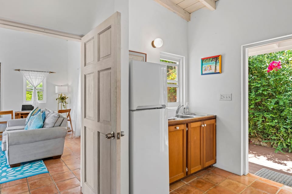 Makere Cottage front door into kitchen looking through to living room.