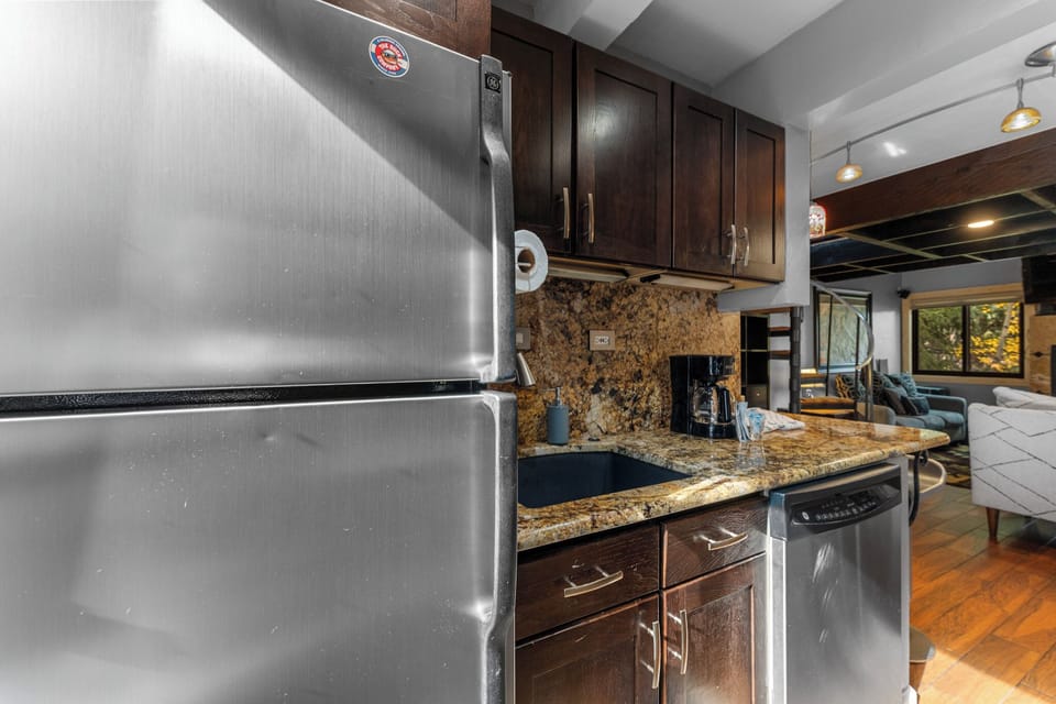 Your fully-equipped kitchen features granite countertops, stainless steel appliances, and rich cabinetry—perfect for preparing meals during your stay.