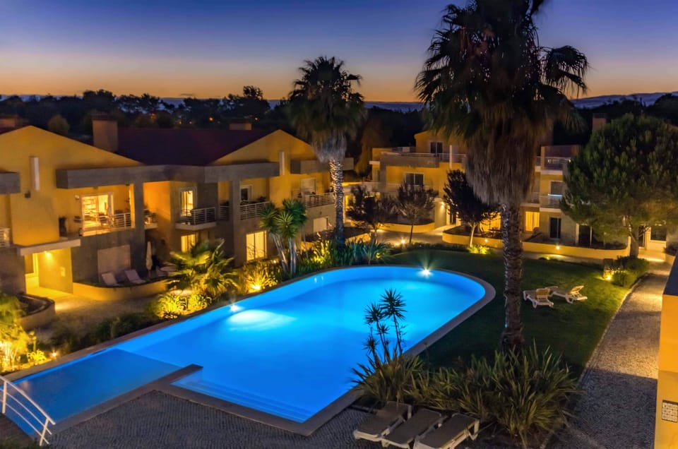 Condominium pool illuminated at night, seen from the comfort of your private rooftop