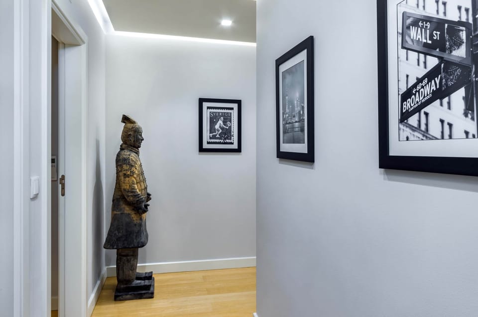 Corridor with gallery wall leading to kitchen, living room & rooftop